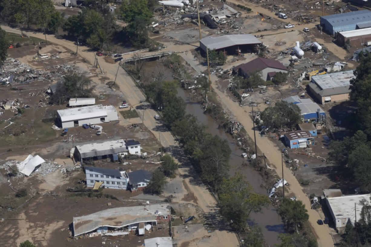 FILE - A view of damage in Asheville, N.C., is seen during an aerial tour with President Joe Biden who looked at areas impacted by Hurricane Helene near Asheville, N.C., Oct. 2, 2024.