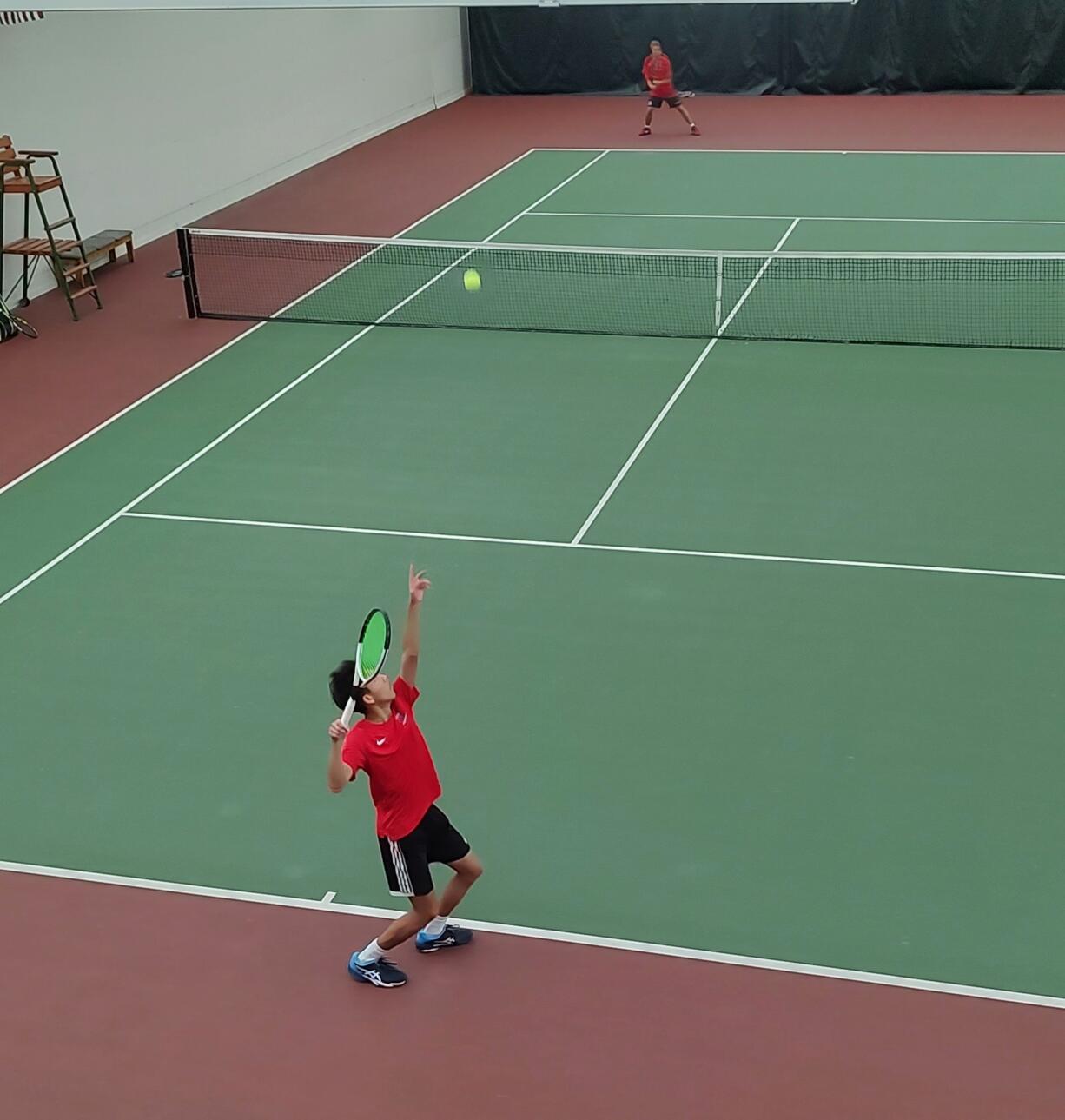 Leo Zhao of Camas serves to Aaron Li, also of Camas, during the 4A District 4 boys tennis singles final on Saturday, Oct. 26, 2024, at Club Green Meadows. Zhao won the marathon match 1-6, 6-0, 7-5 for his first district title.