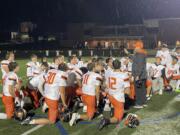 Washougal coach Dave Hajek, right, talks to his team following the Panthers' win over Columbia River in a 2A GSHL football game on Friday, Oct. 25, 2024, at Columbia River High School.