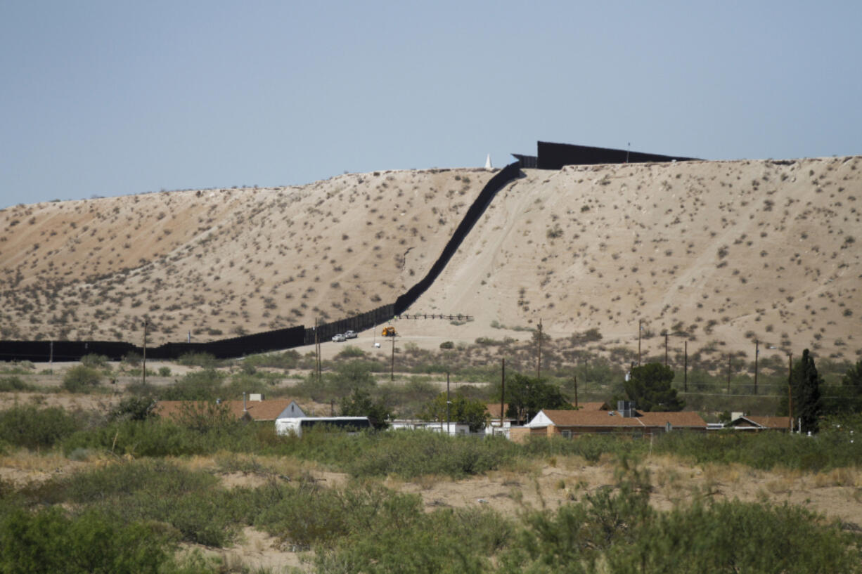 Border Patrol vehicles survey a steel fence at the Southwest border with Mexico at Sunland Park, N.M., Thursday, Aug. 22, 2024.