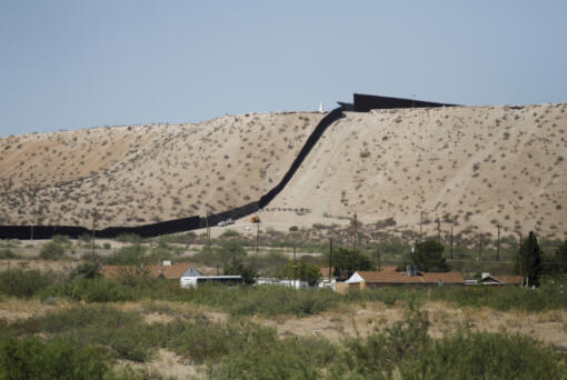 Border Patrol vehicles survey a steel fence at the Southwest border with Mexico at Sunland Park, N.M., Thursday, Aug. 22, 2024.