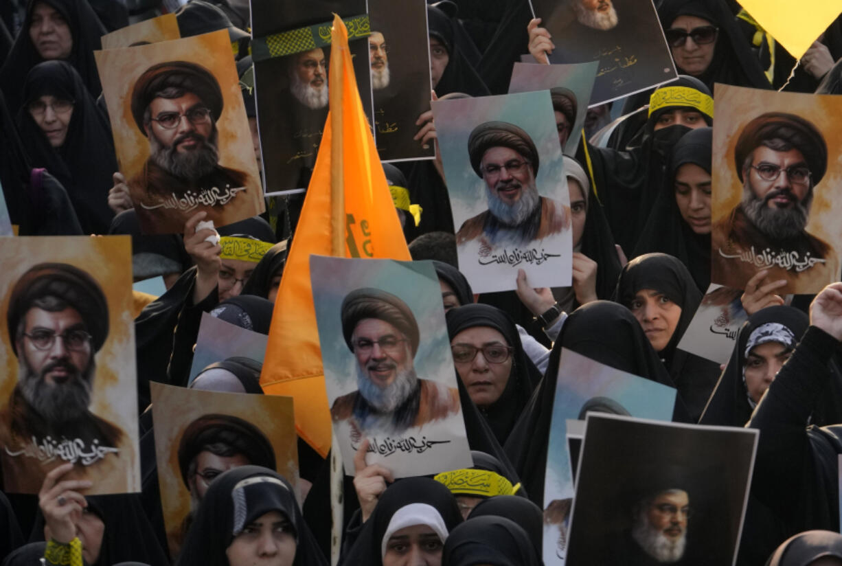 Mourners attend a rally commemorating slain Hezbollah leader Hassan Nasrallah as they hold up posters of him, at Enqelab-e-Eslami (Islamic Revolution) St. in downtown Tehran, Iran, Monday, Sept. 30, 2024.