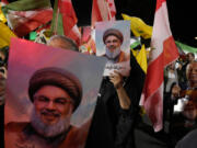 Iranian demonstrators hold posters of slain Hezbollah leader Hassan Nasrallah during an anti-Israeli protest at Felestin (Palestine) Square in Tehran, Iran, Tuesday, Oct. 1, 2024.