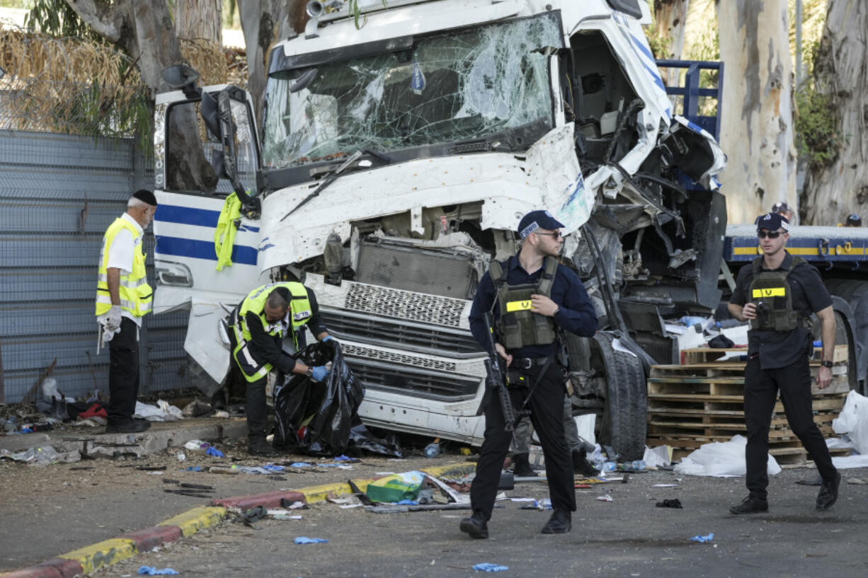 Israeli police and rescue services inspect the site where a truck driver rammed into a bus stop near the headquarters of Israel&#039;s Mossad spy agency, wounding dozens of people, according to Israel&#039;s Magen David Adom rescue service in Tel Aviv, Israel, Sunday, Oct. 27, 2024.