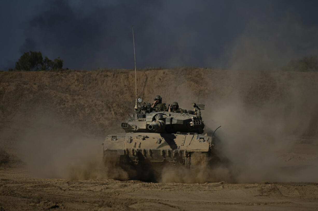 An Israeli army tank maneuvers near the Israel-Gaza border in southern Israel on Sunday.