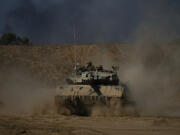 An Israeli army tank maneuvers near the Israel-Gaza border in southern Israel on Sunday.