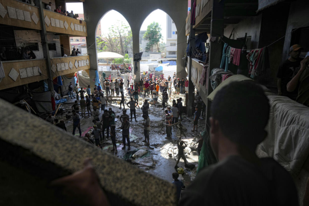 Palestinians inspect the damage of a school hit by an Israeli bombardment on Deir al-Balah, central Gaza Strip, Thursday, Oct. 10, 2024.