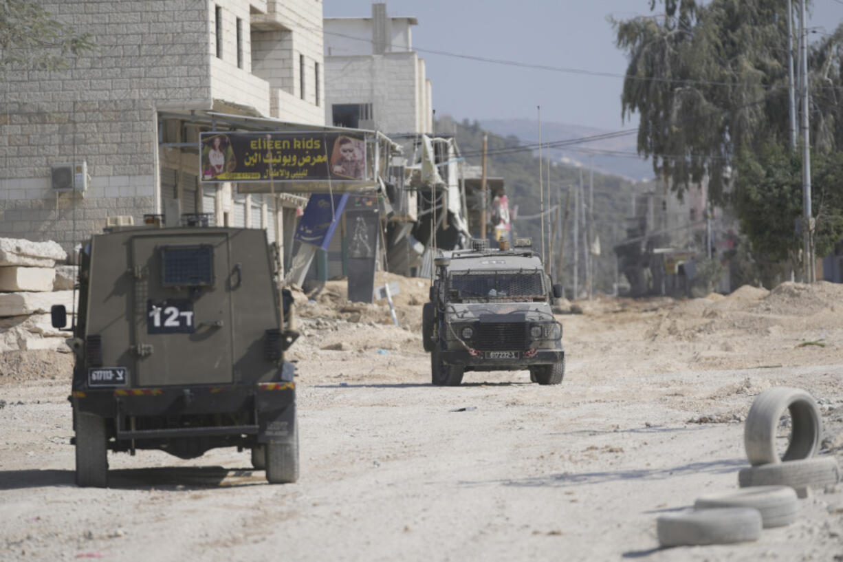 Israeli army units secure the parameter of the Nur Shams refugee camp during the ongoing army operation, after the Palestinian Health Ministry said two Palestinians were killed in an Israeli strike and a third by Israeli gunfire, in the West Bank city of Tulkarem Thursday, Oct. 31, 2024.