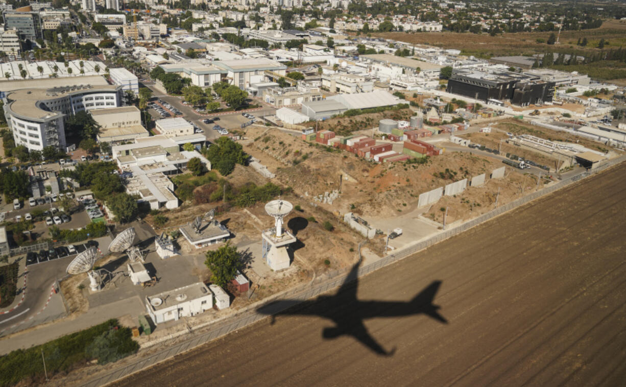 An aircraft carrying U.S. Secretary of State Antony Blinken casts a shadow on the ground as it descends in Tel Aviv, Israel Tuesday, Oct. 22, 2024.