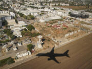 An aircraft carrying U.S. Secretary of State Antony Blinken casts a shadow on the ground as it descends in Tel Aviv, Israel Tuesday, Oct. 22, 2024.