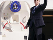 U.S. Secretary of State Antony Blinken waves as he departs for Riyadh, Saudi Arabia, from Ben Gurion International Airport in Tel Aviv, Israel, Wednesday, Oct. 23, 2024.