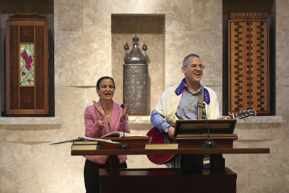 Gayle Pomerantz, left, senior rabbi at Temple Beth Sholom, and Cantor Juval Porat sing Sept. 27 during a Shabbat service in Miami Beach, Fla.