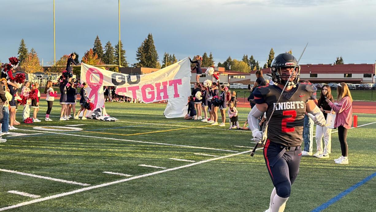 King's Way Christian football player Jace Barnes runs onto the field with a sword before the Knights' Class 1A Trico League game against Stevenson on Friday, Oct. 11, 2024.