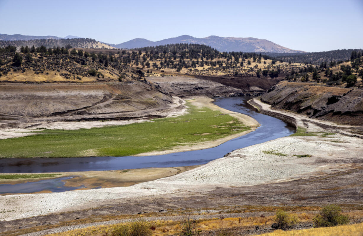 FILE - The Klamath River flows where Iron Gate Reservoir once was as work to remove of the Iron Gate and Copco Dams continues on the Klamath River near Hornbook, Calif., July 25, 2024.