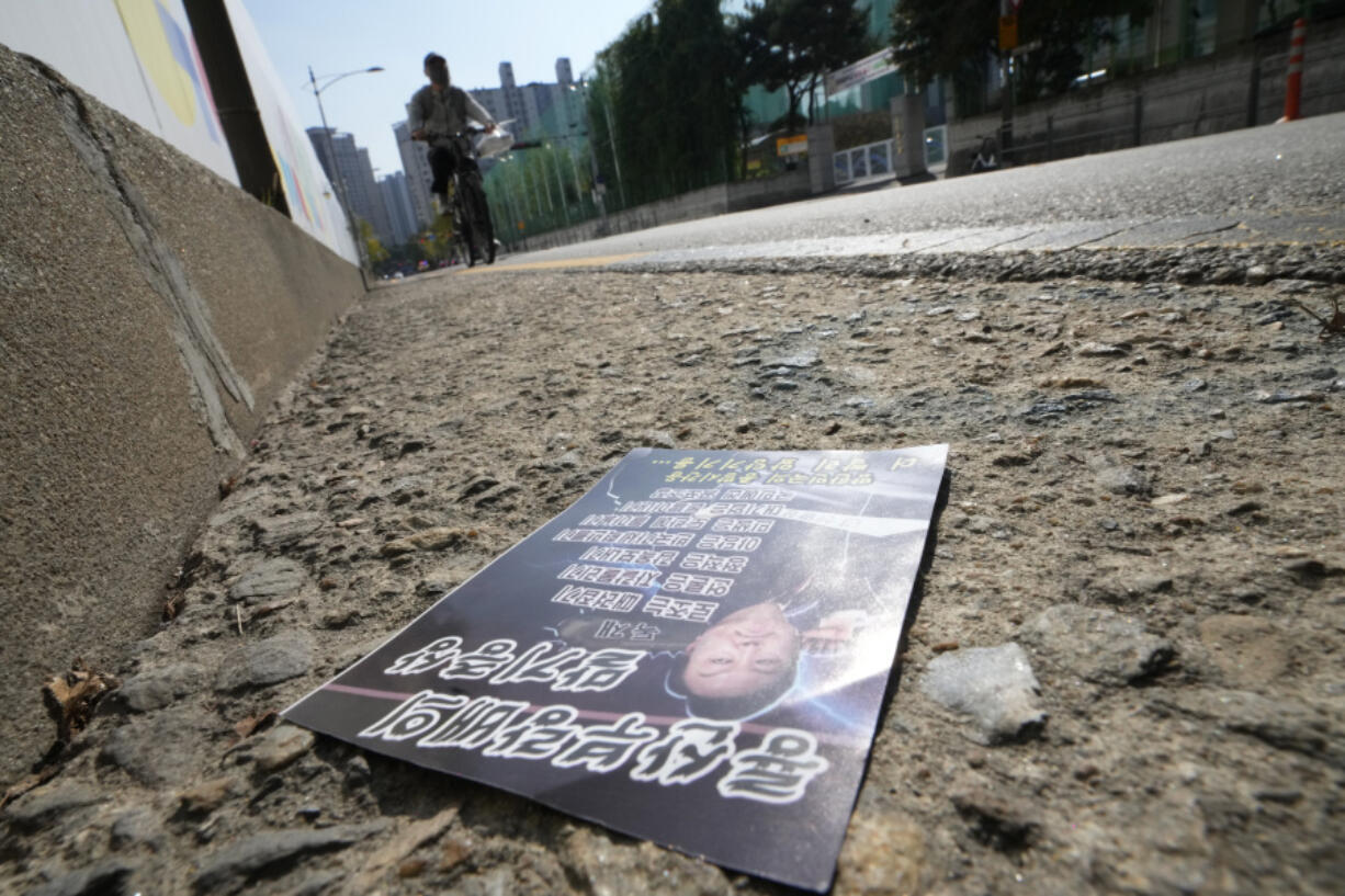 A propaganda leaflet showing South Korean President Yoon Suk Yeol presumably sent by North Korea is seen on a road in Seoul, South Korea, Thursday, Oct. 24, 2024.