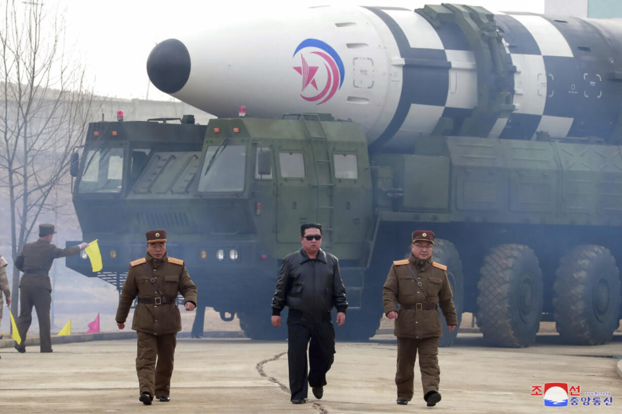 FILE - In this photo distributed by the North Korean government, North Korean leader Kim Jong Un, center, walks near what it says is a Hwasong-17 intercontinental ballistic missile (ICBM) on the launcher at an undisclosed location in North Korea on March 24, 2022. Independent journalists were not given access to cover the event depicted in this image distributed by the North Korean government. The content of this image is as provided and cannot be independently verified. Korean language watermark on image as provided by source reads: &ldquo;KCNA&rdquo; which is the abbreviation for Korean Central News Agency.