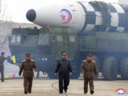 FILE - In this photo distributed by the North Korean government, North Korean leader Kim Jong Un, center, walks near what it says is a Hwasong-17 intercontinental ballistic missile (ICBM) on the launcher at an undisclosed location in North Korea on March 24, 2022. Independent journalists were not given access to cover the event depicted in this image distributed by the North Korean government. The content of this image is as provided and cannot be independently verified. Korean language watermark on image as provided by source reads: &ldquo;KCNA&rdquo; which is the abbreviation for Korean Central News Agency.