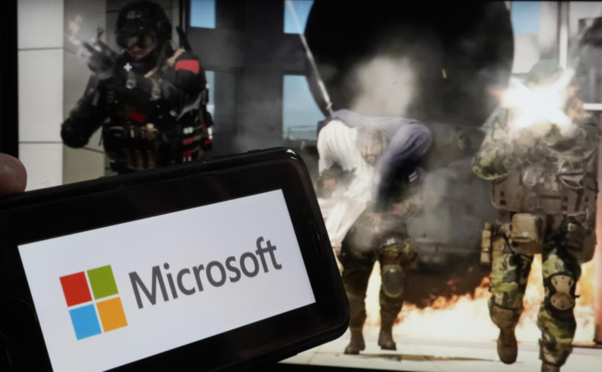 FILE - The logo for Microsoft, and a scene from Activision &ldquo;Call of Duty - Modern Warfare,&rdquo; are shown in this photo, in New York, June 21, 2023.