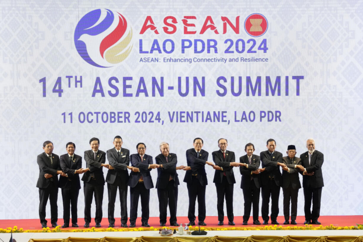 From left to right, Myanmar Foreign Ministry Permanent Secretary Aung Kyaw Moe, Philippine&rsquo;s President Ferdinand Marcos Jr., Singaporean Prime Minister Lawrence Wong, Thailand&rsquo;s Foreign Minister Maris Sangiampongsa, Vietnamese Prime Minister Pham Minh Chinh, U.N. Secretary-General Antonio Guterres, Laos&rsquo; Prime Minister Sonexay Siphandone, Malaysian Prime Minister Anwar Ibrahim, Brunei Sultan Hassanal Bolkiah, Cambodian Prime Minister Hun Manet, Indonesian Vice President Ma&rsquo;ruf Amin and East Timorese Prime Minister Xanana Gusmao hold hands during the 14th ASEAN-U.N. Summit in Vientiane, Laos, Friday, Oct. 11, 2024.