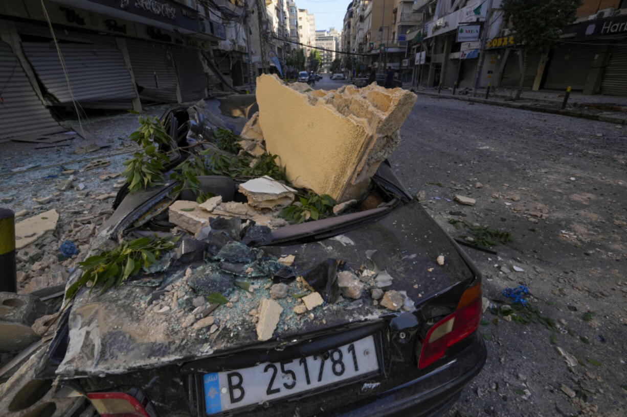 A wrecked car parked next to the site of an Israeli airstrike in Dahiyeh, Beirut, Lebanon, Thursday, Oct. 3, 2024.