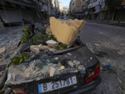 A wrecked car parked next to the site of an Israeli airstrike in Dahiyeh, Beirut, Lebanon, Thursday, Oct. 3, 2024.