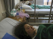 Yasmina Khalifa, background, and her sister, Julia, who were injured in an Israeli airstrike that hit their building Tuesday night, lie in hospital beds Wednesday in Sarafand, southern Lebanon.