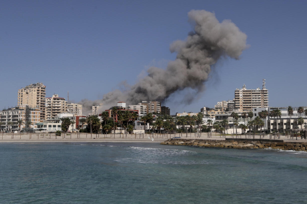 Smoke rises from buildings hit in an Israeli airstrike in Tyre, Lebanon, Wednesday, Oct. 23, 2024.