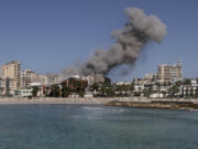 Smoke rises from buildings hit in an Israeli airstrike in Tyre, Lebanon, Wednesday, Oct. 23, 2024.