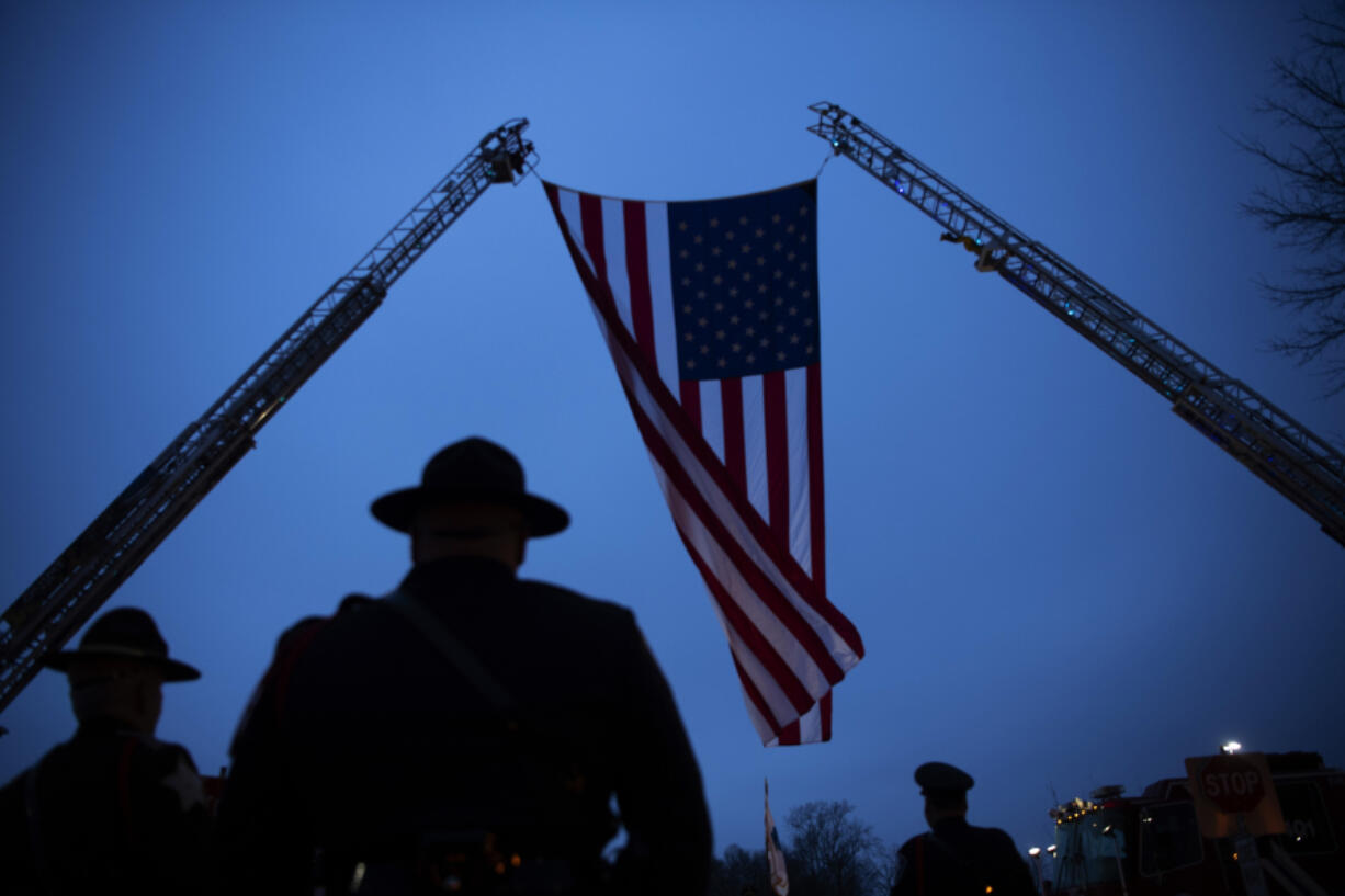 A garrison flag is adjusted before the funeral of Vanderburgh County Sheriff&rsquo;s Deputy Asson Hacker at Christian Fellowship Church on the evening of March 9, 2023.