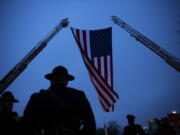 A garrison flag is adjusted before the funeral of Vanderburgh County Sheriff&rsquo;s Deputy Asson Hacker at Christian Fellowship Church on the evening of March 9, 2023.