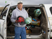 Volunteer beach cleaner Russ Lewis holds detritus of shipping container spills washed up on Washington&rsquo;s Long Beach Peninsula in Pacific County, Wash., Monday, June 17, 2024.