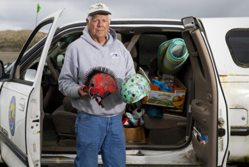 Volunteer beach cleaner Russ Lewis holds detritus of shipping container spills washed up on Washington&rsquo;s Long Beach Peninsula in Pacific County, Wash., Monday, June 17, 2024.