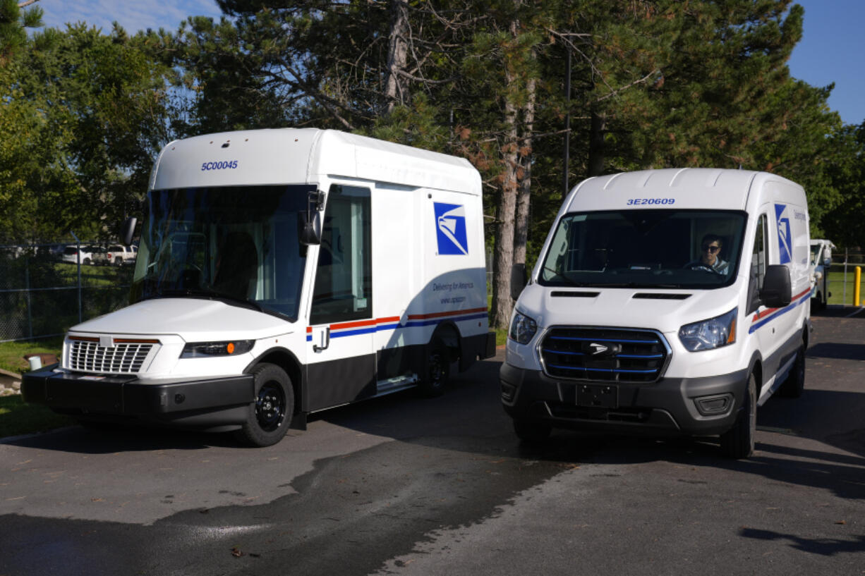 FILE - The U.S. Postal Service&rsquo;s next-generation delivery vehicle, left, is displayed as one new battery electric delivery trucks leaves the Kokomo Sorting and Delivery Center in Kokomo, Ind., Thursday, Aug. 29, 2024.