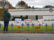 FILE - A woman visits a makeshift memorial outside Sparetime Bowling Alley, the site of a mass shooting, Oct. 28, 2023, in Lewiston, Maine. (AP Photo/Robert F.