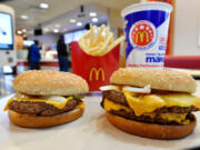 FILE- In this March 6, 2018, file photo, a McDonald&#039;s Quarter Pounder, left, and Double Quarter Pound burger is shown in Atlanta.