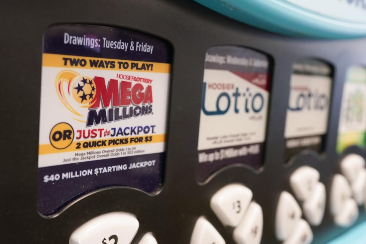 FILE - A Mega Millions logo is displayed on a vending machine at the Hoosier Lottery booth at the Indiana State Fair, Thursday, Aug. 3, 2023, in Indianapolis.