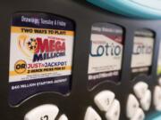 FILE - A Mega Millions logo is displayed on a vending machine at the Hoosier Lottery booth at the Indiana State Fair, Thursday, Aug. 3, 2023, in Indianapolis.