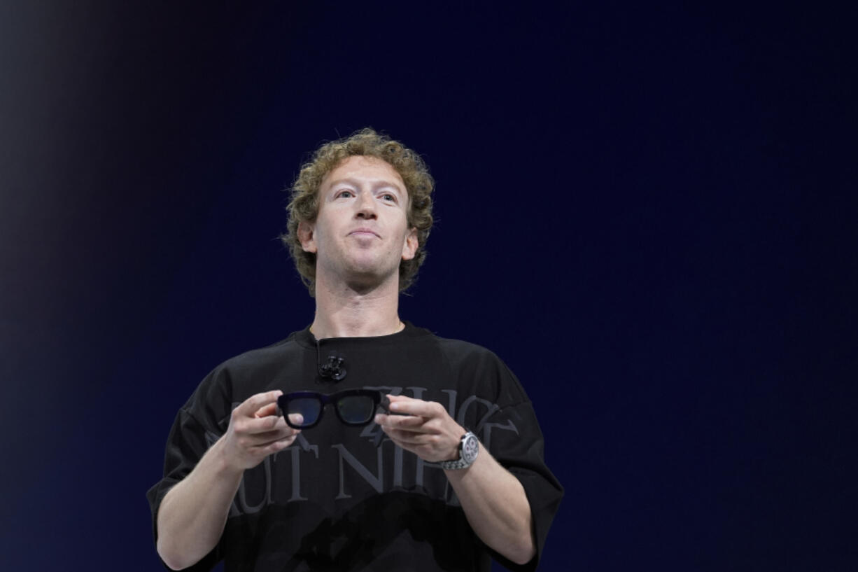 FILE - Mark Zuckerberg holds a pair of Orion AR glasses during the Meta Connect conferenceSept. 25, 2024, in Menlo Park, Calif. (AP Photo/Godofredo A.