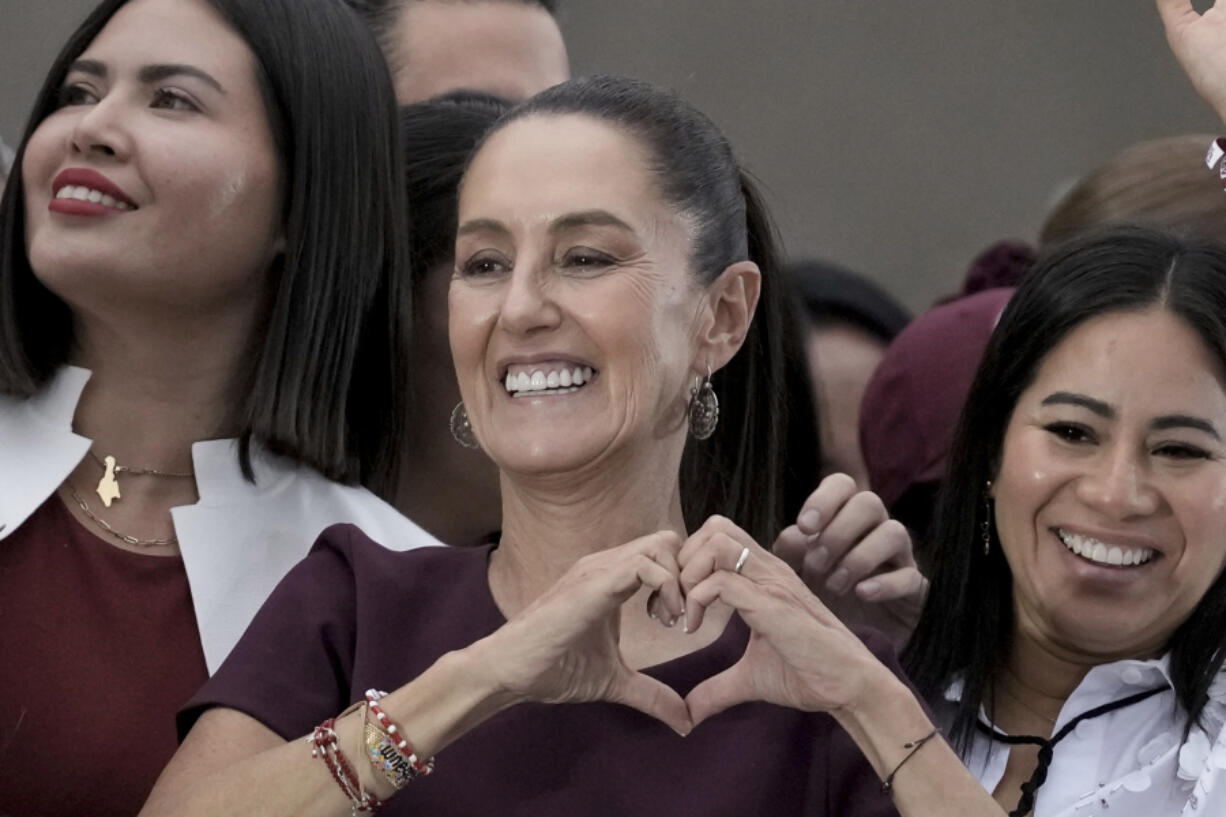 FILE - Presidential candidate Claudia Sheinbaum flashes a hand-heart sign during her closing campaign rally at the Zocalo in Mexico City, May 29, 2024. Sheinbaum, a climate scientist and former Mexico City mayor, will be sworn in as Mexico&rsquo;s first woman president on Oct. 1.