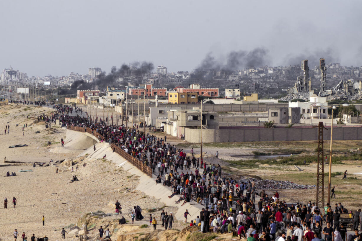 FILE - Palestinians are waiting for aid trucks to cross in central Gaza Strip on May 19, 2024.