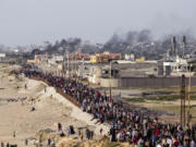 FILE - Palestinians are waiting for aid trucks to cross in central Gaza Strip on May 19, 2024.