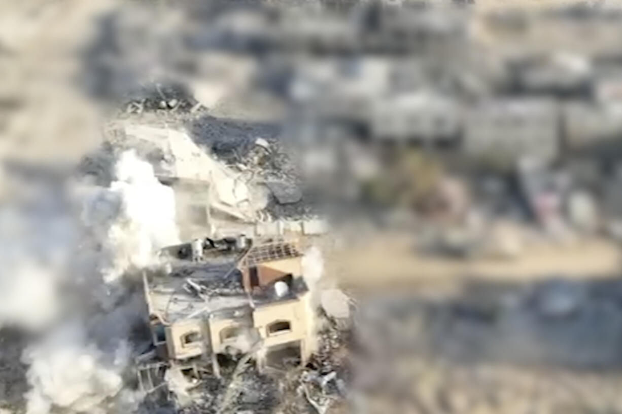 This still image from video provided by the Israel Defense Force (IDF) shows an explosion in a building in which they say Hamas leader Yahya Sinwar was barricaded immediately after is was fired upon by an Israeli tank in Rafah, Gaza Strip, Wednesday, Oct. 16, 2024. The area of the image around the building was blurred by the source.