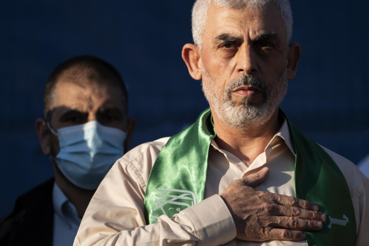 FILE - Yahya Sinwar, Palestinian leader of Hamas in the Gaza Strip, places his hand over his heart on stage after greeting supporters at a rally on May 24, 2021, in Gaza City, the Gaza Strip.