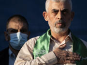 FILE - Yahya Sinwar, Palestinian leader of Hamas in the Gaza Strip, places his hand over his heart on stage after greeting supporters at a rally on May 24, 2021, in Gaza City, the Gaza Strip.