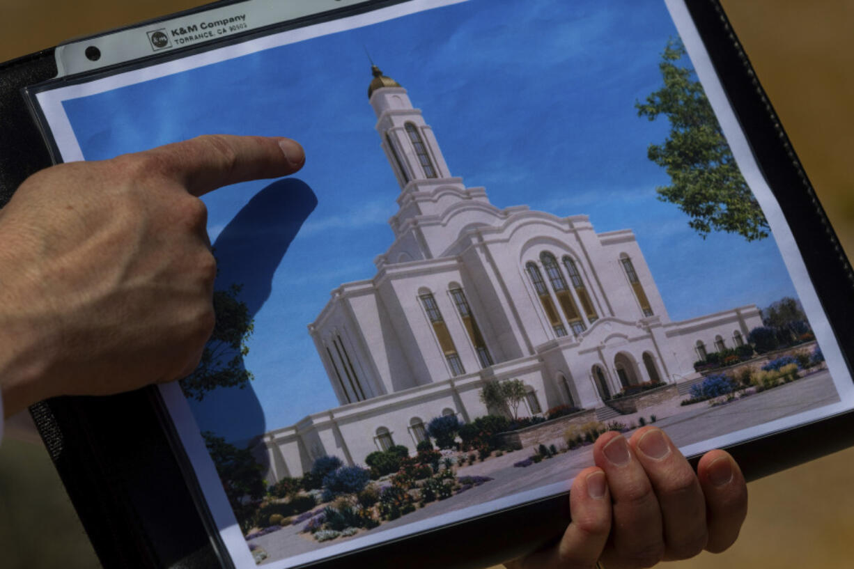 Bud Stoddard, a regional church leader, holds a rendering of the temple planned by The Church of Jesus Christ of Latter-day Saints at a site near Las Vegas on May 16.