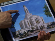 Bud Stoddard, a regional church leader, holds a rendering of the temple planned by The Church of Jesus Christ of Latter-day Saints at a site near Las Vegas on May 16.