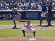 New York Mets&#039; Mark Vientos, left, follows his grand slam home run as Los Angeles Dodgers relief pitcher Landon Knack, center, watches along with catcher Will Smith during second inning in Game 2 of a baseball NL Championship Series, Monday, Oct. 14, 2024, in Los Angeles. (AP Photo/Mark J.