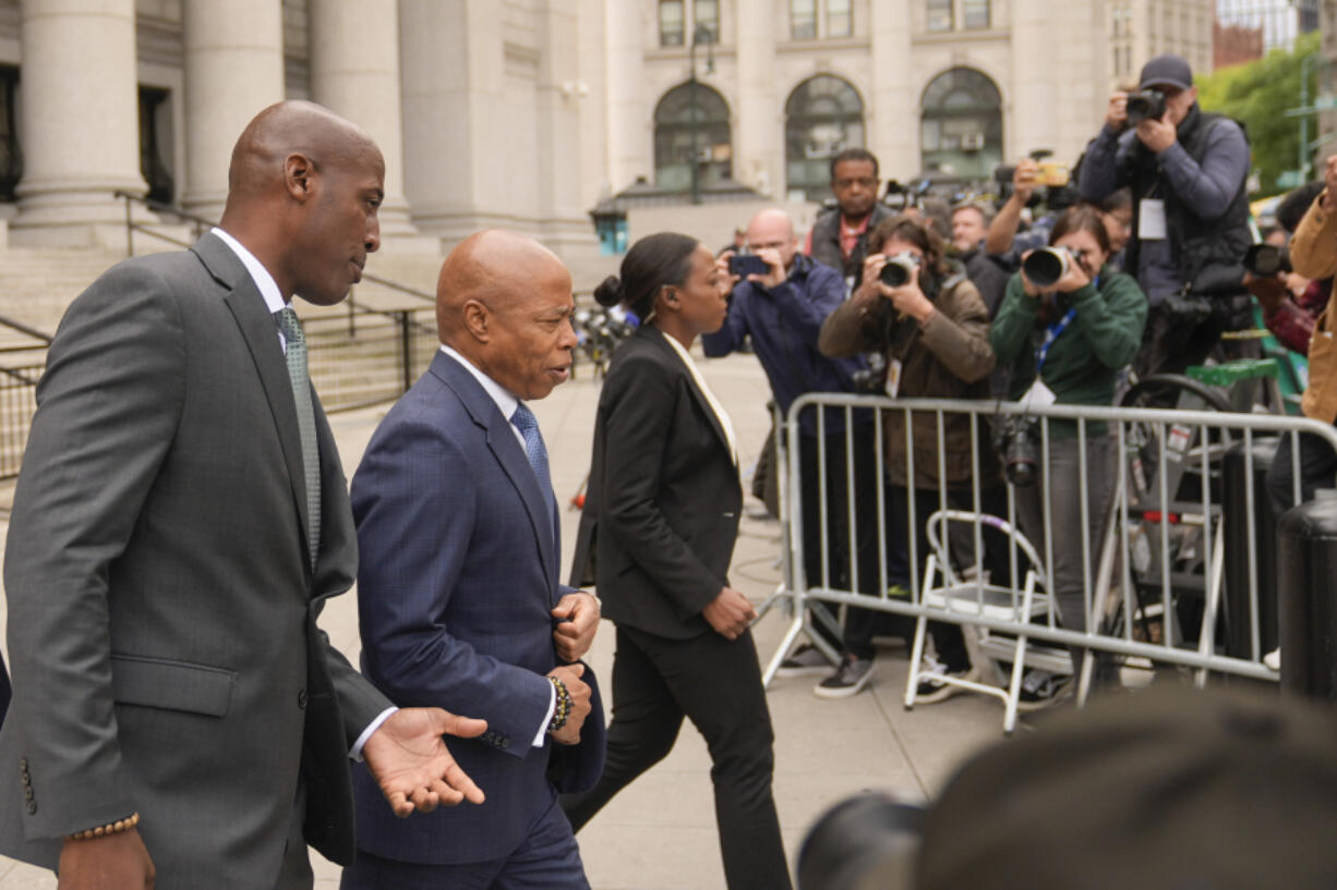 New York City Mayor Eric Adams, second from left, leaves the courthouse in New York, Wednesday, Oct. 2, 2024.