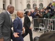 New York City Mayor Eric Adams, second from left, leaves the courthouse in New York, Wednesday, Oct. 2, 2024.