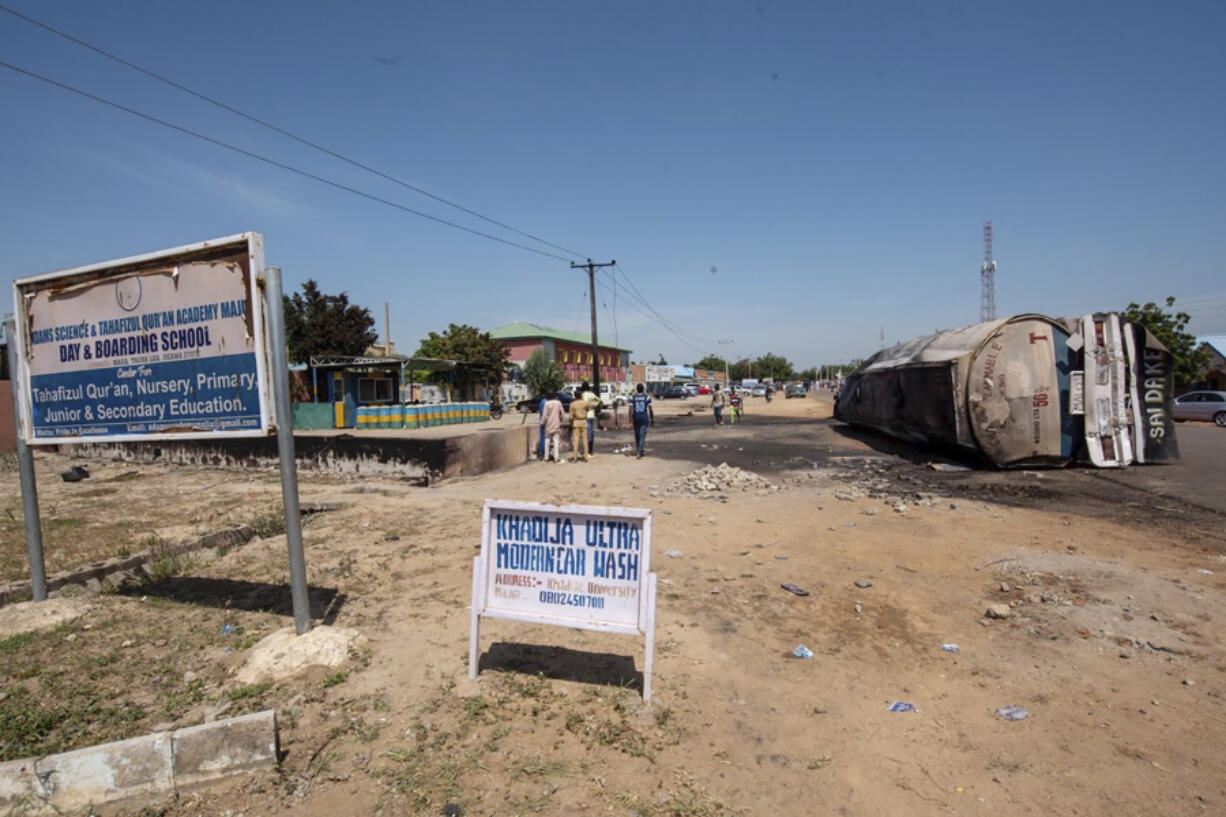 People gather at the scene of a tanker explosion in Majiya town Nigeria, Wednesday, Oct.16, 2024.